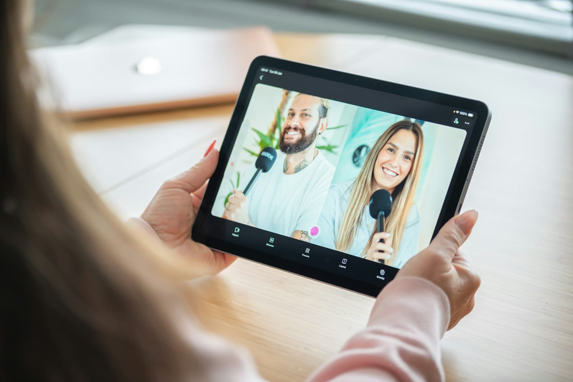 Remote podcast guests displayed on a tablet during an online recording