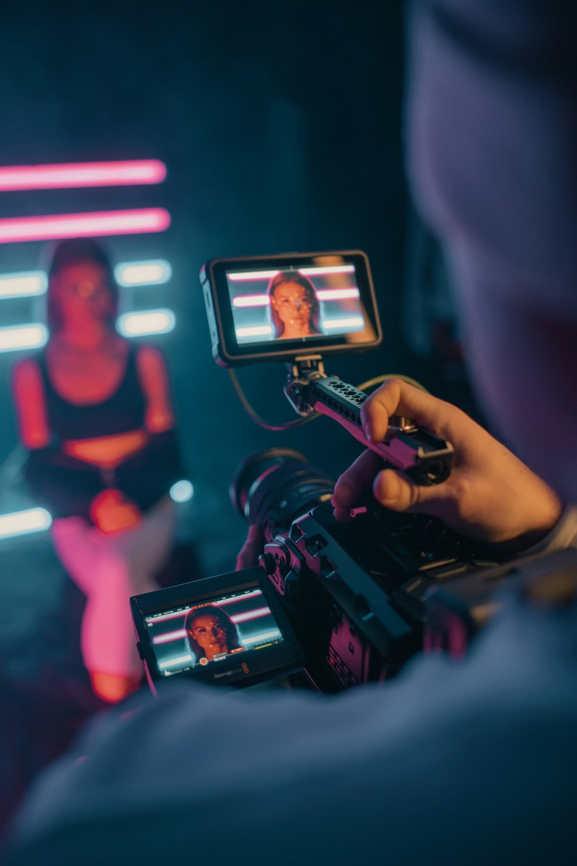 Professional camera recording a presenter in a colourful YouTube production studio